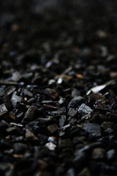 Detailed close-up of charcoal briquettes showing textures and shades.